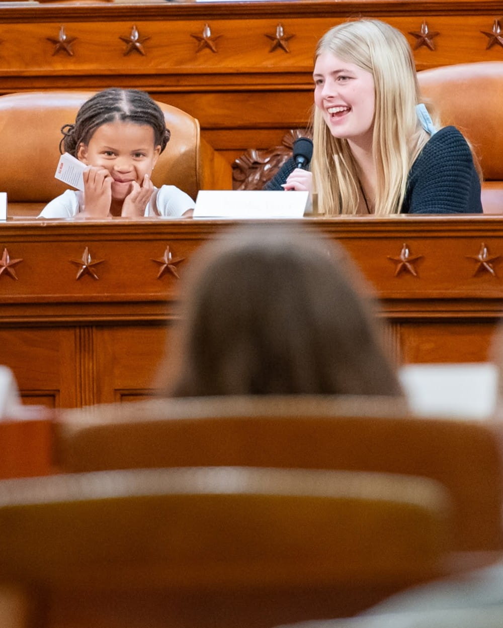 A young girl sits in Congress.