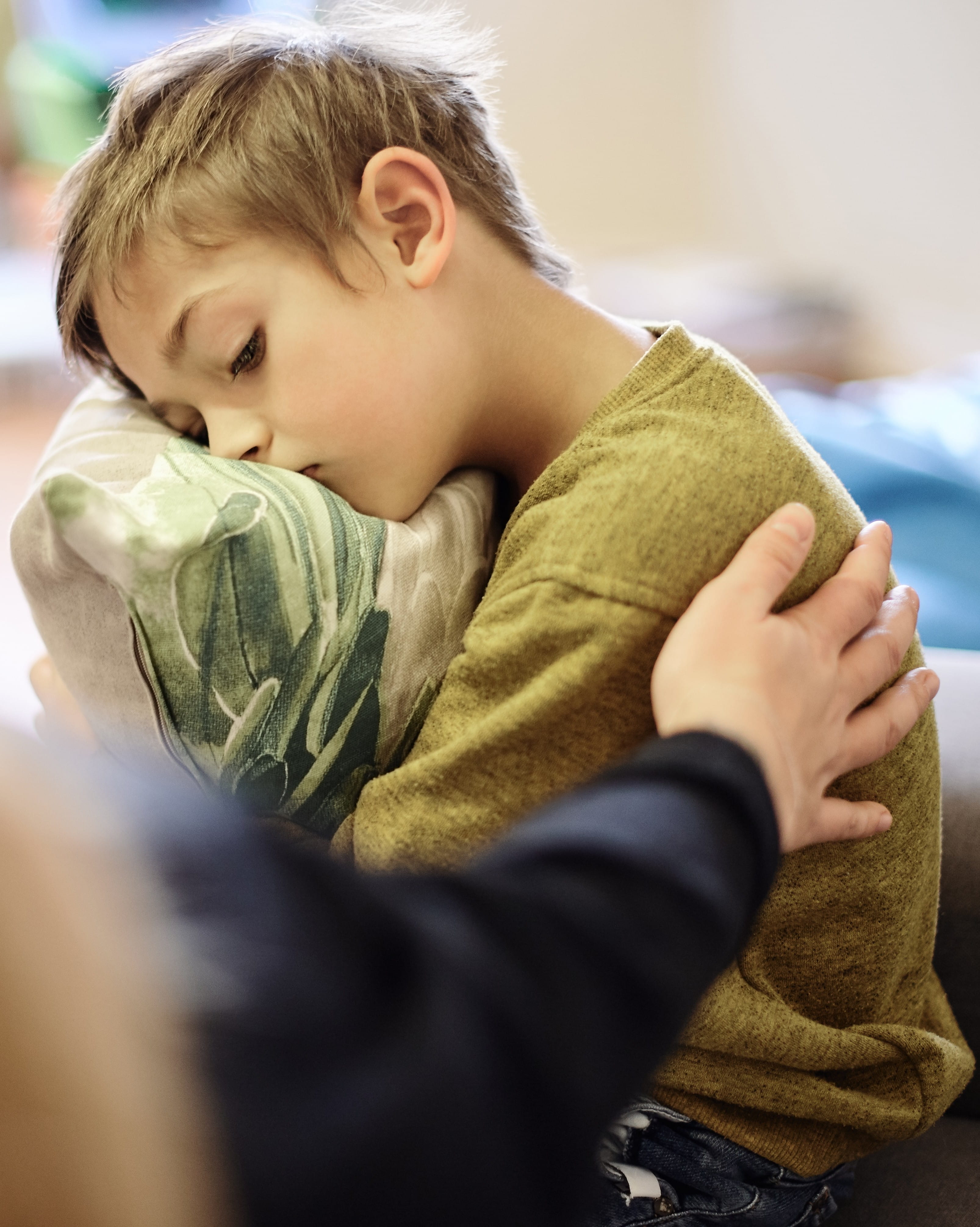 Mom comforts little boy.