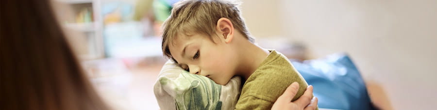 Mom comforts little boy.