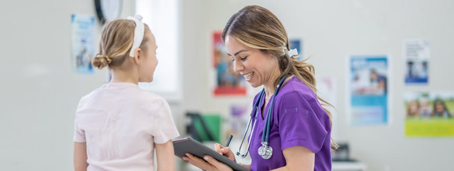 Medical staff examines patient and records notes in EMR.
