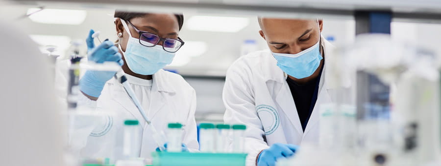 Two medical professionals working in a lab.