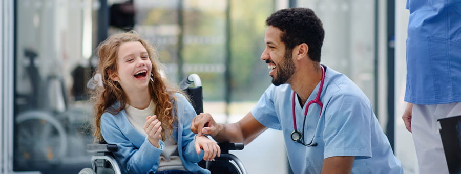 Happy child patient and nurse laughing.