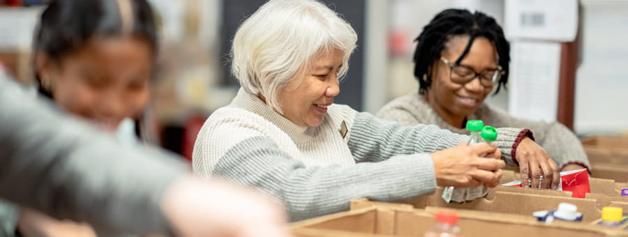 Women packing food into boxes.