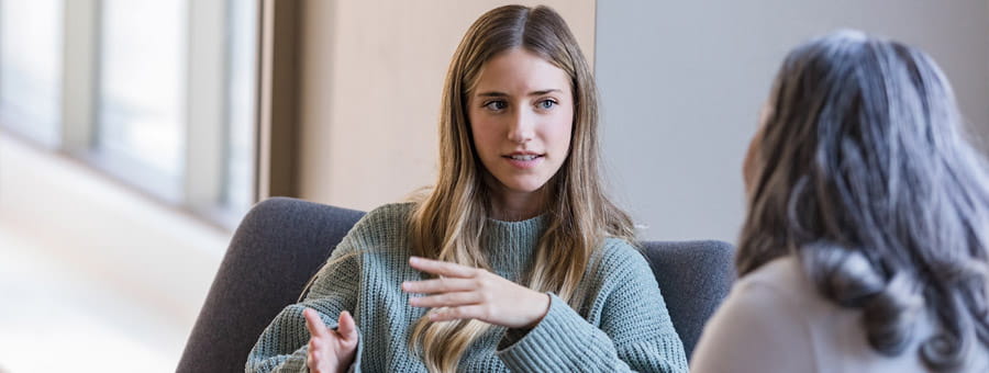 Teen girl speaks to therapist.