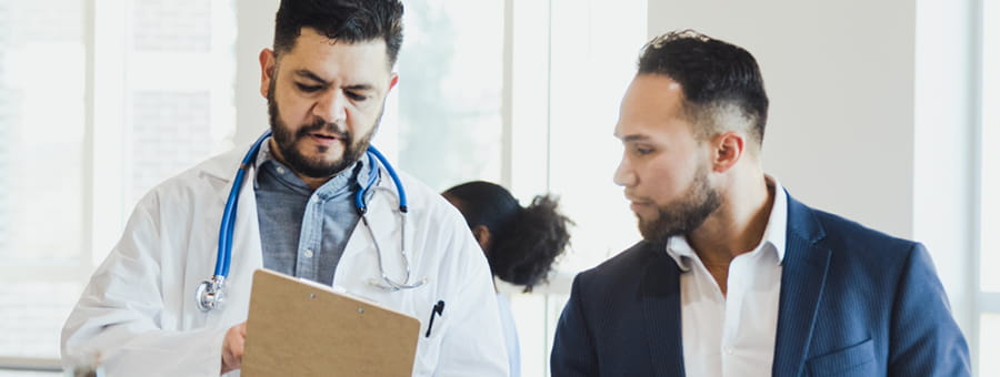 Doctor talking with hospital administrator.