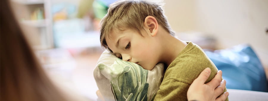 Mom comforts little boy.