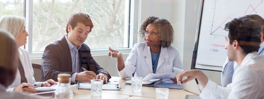 A group of professionals sitting around a table talking