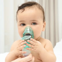 A baby uses a nebulizer.