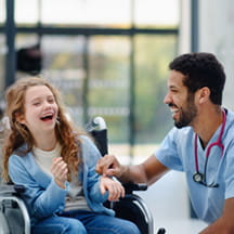Happy child patient and nurse laughing.