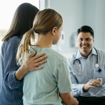 Physician talking to patient and parent
