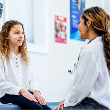 Doctor speaks with young patient.