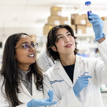 Two researchers inspect sample