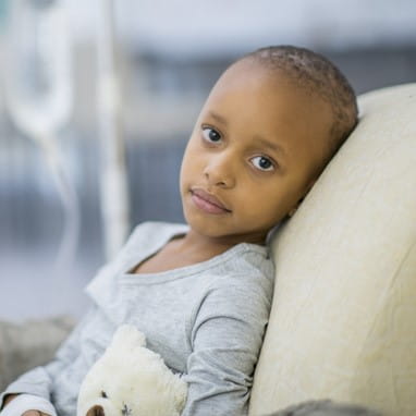 Child patient in a hospital bed.
